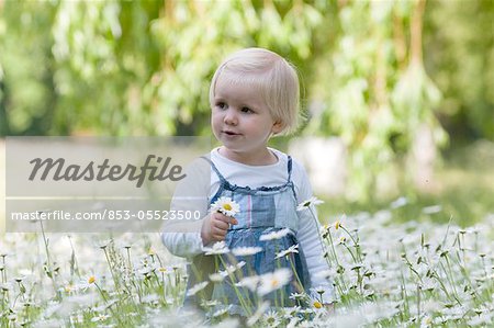 Blond girl on a flower meadow