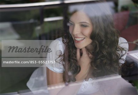 Young woman looking out of the window