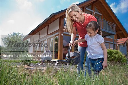 Family in front of Lehner energy house, Poing, Bavaria, Germany, Europe