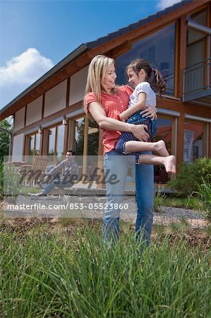 Family in front of Lehner energy house, Poing, Bavaria, Germany, Europe
