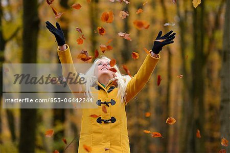 Happy blond young woman in forest