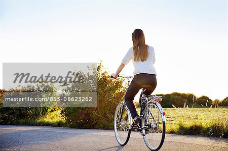 Young woman cycling, Bavaria, Germany, Europe