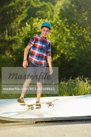 Boy with skateboard in a skatepark