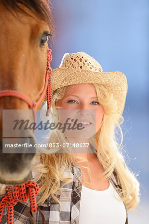 Young woman beside a horse, portrait