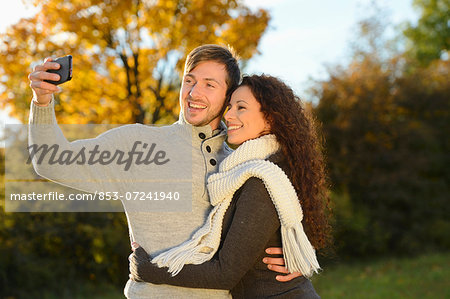 Happy couple in autumn taking a self portrait
