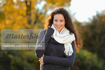 Smiling young woman in autumn, portrait