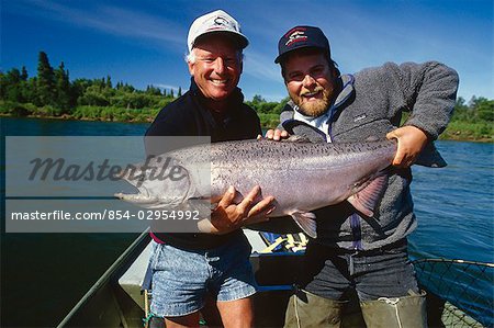 Fisherman & guide holding large king salmon in boat Nushagak River Southwest AK Summer