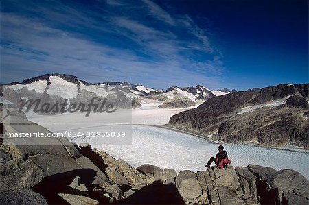 Hiker sitting rocks Juneau Ice Field Mendenhall Southeast Alaska Glacier summer scenic