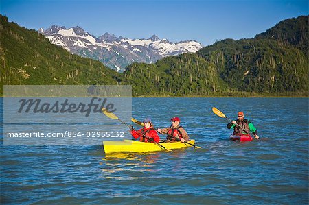 Kayakers on Big River Lakes with Tordillo Mountains in the background in the Redoubt Bay State Critical Habitat Area during Summer in Southcentral Alaska
