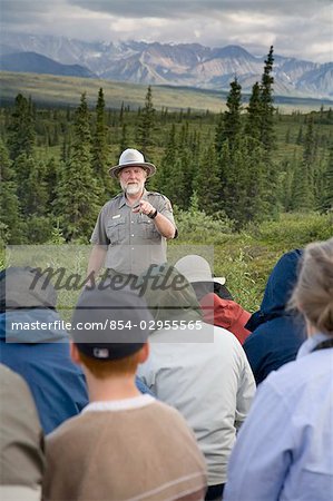 US National Park Interpretive Ranger gives a nature talk to visitors gathered at the Wonder Lake campground in Denali National Park Alaska