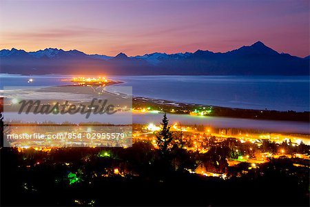 Early morning view of the Homer Spit as night gives way to the dawn over the Kenai Mountains and Kachemak Bay on the Kenai Peninsula of Southcentral Alaska