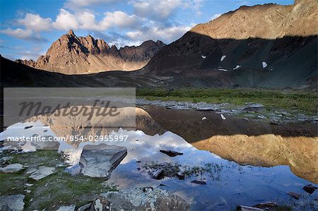 Clearwater Mountains reflecting in lake in Interior, Alaska during Summer