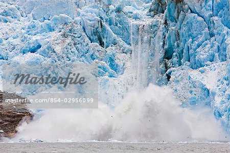 Dawes Glacier calves into the Endicott Arm fjord of Tracy Arm in Fords Terror Wilderness, Southeast, Alaska during Summer