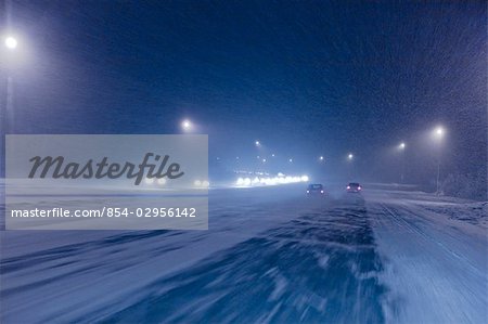 Rush hour commmuter traffic on the Glen highway during a snow storm in Anchorage, Alaska