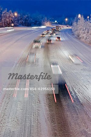 Rush hour commmuter traffic on the Glen highway during a snow storm in Anchorage, Alaska