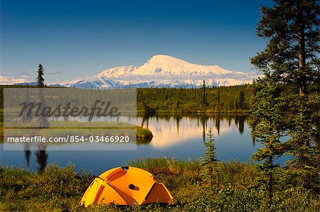 Tent camping in Wrangell Saint Elias National Park with Mount Sanford in the background, Southcentral Alaska, Summer