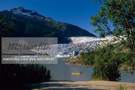 Person kayaking on Mendenhall Lake w/glacier Coast Mtns Tongass Nat Forest Southeast AK Summer