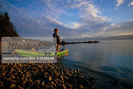 Woman kayaker viewing scenery @ Berners Bay Inside Passage Southeast Alaska Summer Tongass NF