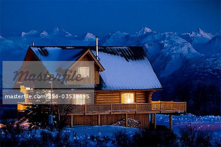 Sunset On A Log Home That Overlooks Kachemak Bay Above Homer On