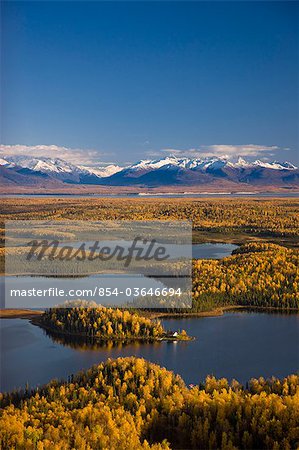 Aerial View of the lakes and Birch forests at Point Mackenzie on the opposite side of Knik Arm from Anchorage with the Chugach Mountains in the background, Southcentral Alaska