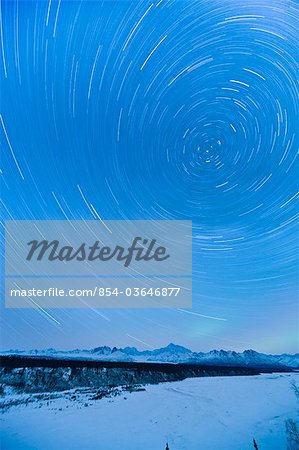 Night time view of star trails over Mt. McKinley with Northern Lights in the background, Denali State Park, Southcentral Alaska, Winter Night time view of star trails over Mt. McKinley with Northern Lights in the background, Denali State Park, Southcentral Alaska, Winter