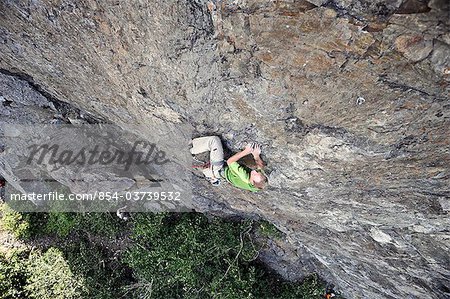 Man rock climbing along Turnagain Arm near Anchorage, Southcentral Alaska, Summer