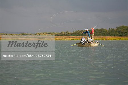 Anglers fly fishing from a boat in Bristol Bay near Crystal Creek Lodge, King Salmon, Southwest Alaska, Summer