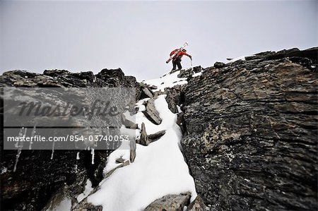 Backpacker climbs the West Ridge of Mt. Chamberlin in the Brooks Range, ANWR, Arctic Alaska, Summer