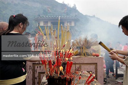 Devotee offering incense at Dai Mui Tin Hau Temple,Hong Kong