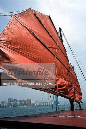 Chinese junk 'Dukling' in Victoria Harbour with Tsimshatsui East skyline at the background,Hong Kong