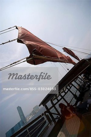 Chinese junk 'Dukling' in Victoria Harbour with Hung Hom skyline at the background,Hong Kong