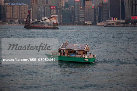 Wanchai skyline from Kowloon with a fancy sightseeing boat in foreground, Hong Kong