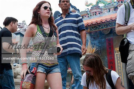 Foreign visitors sharing the atmosphere of the Bun festival at Pak Tai Temple, Cheung Chau, Hong Kong