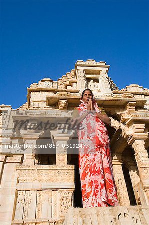Woman standing in a prayer position in front of a temple, Kumbha Shyam Temple, Chittorgarh, Rajasthan, India