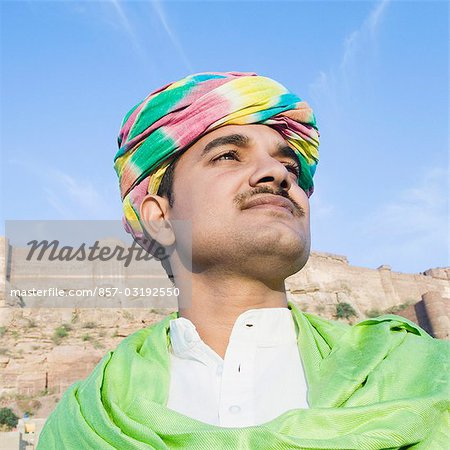 Man with fort in the background, Meherangarh Fort, Jodhpur, Rajasthan, India