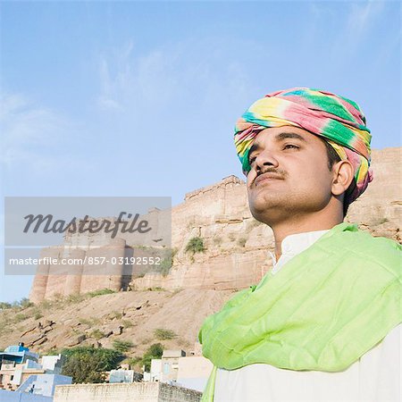 Man with fort in the background, Meherangarh Fort, Jodhpur, Rajasthan, India