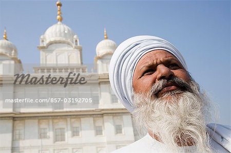 Man with Gurudwara in the background, Sikh Temple, Gwalior, Madhya Pradesh, India