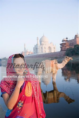 Woman at the riverbank with mausoleum in the background, Taj Mahal, Yamuna River, Agra, Uttar Pradesh, India