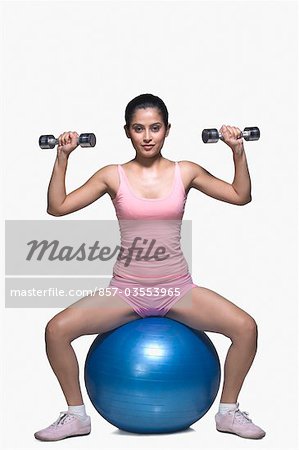 Young woman exercising on a fitness ball