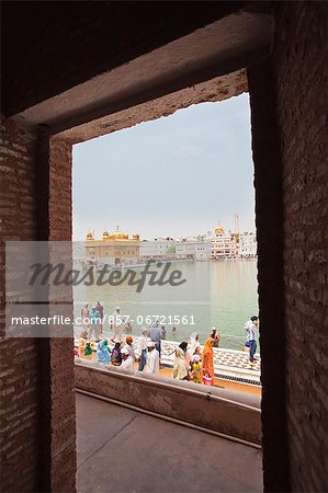 Devotees at a temple viewed through a gate, Golden Temple, Amritsar, Punjab, India