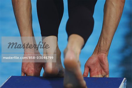 Swimmer on diveboard preparing