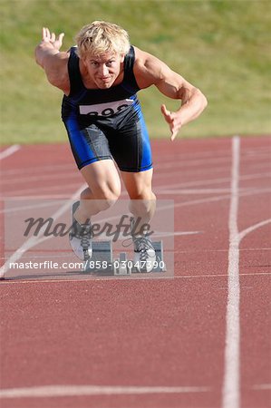 Sprinter taking position on a starting block to start her sprint – Jacob  Lund Photography Store- premium stock photo