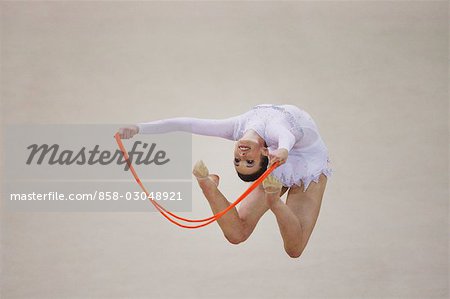 Young woman performing rhythmic gymnastics with rope