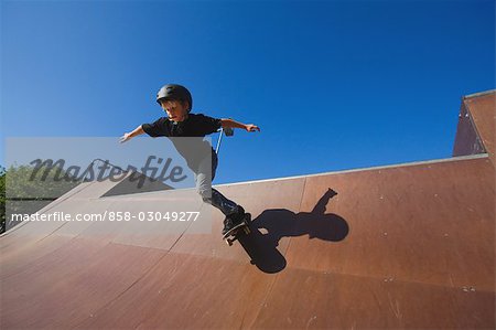 Boy skateboarding in skate park
