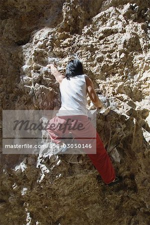 Climber Scaling a Rock Face