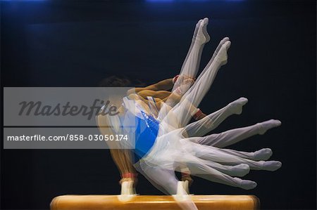 A male gymnast performing on pommel horse