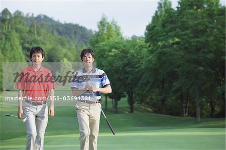 Men Walking On Golf Course