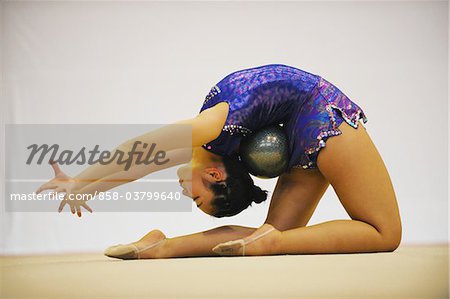 Young female athlete performing gymnastics