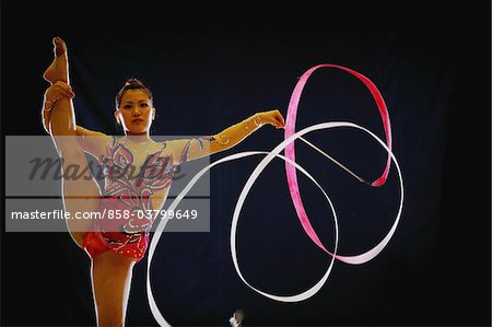 Woman acrobat performing with ribbon