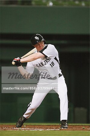 Batter holding bat while playing baseball